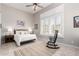 Cozy bedroom featuring a ceiling fan, plantation shutters, and a classic rocking chair at 42429 N Cross Timbers Ct, Anthem, AZ 85086