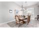 Formal dining room with chandelier and large windows with plantation shutters at 42429 N Cross Timbers Ct, Anthem, AZ 85086