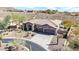 Aerial view of home with three car garage and desert landscaping at 42429 N Cross Timbers Ct, Anthem, AZ 85086