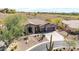 Aerial front view of a home with three car garage and desert landscaping at 42429 N Cross Timbers Ct, Anthem, AZ 85086