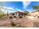 Exterior of the home with desert landscaping, and a backyard seating area at 42429 N Cross Timbers Ct, Anthem, AZ 85086