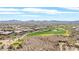 View of the community golf course with desert homes in the background at 42429 N Cross Timbers Ct, Anthem, AZ 85086