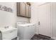 Bright laundry room featuring cabinetry, utility sink, and washer and dryer at 42429 N Cross Timbers Ct, Anthem, AZ 85086