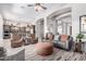 Open-concept living room with a view to the kitchen, lots of seating, and natural light at 42429 N Cross Timbers Ct, Anthem, AZ 85086