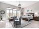 Bright main bedroom featuring large windows, neutral tones, and a cozy seating area at 42429 N Cross Timbers Ct, Anthem, AZ 85086