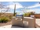 Outdoor kitchen featuring stainless steel grill, concrete countertops, and desert landscaping at 42429 N Cross Timbers Ct, Anthem, AZ 85086