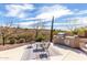 Outdoor kitchen and seating area overlooking desert landscape views at 42429 N Cross Timbers Ct, Anthem, AZ 85086