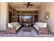 Relaxing outdoor living space featuring wicker furniture and ceiling fan at 42429 N Cross Timbers Ct, Anthem, AZ 85086