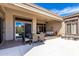 Covered patio with dining table, outdoor seating, and mountain views at 42429 N Cross Timbers Ct, Anthem, AZ 85086