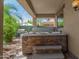 Relaxing backyard featuring a hot tub, covered patio, and mature landscaping at 4245 S 247Th Dr, Buckeye, AZ 85326