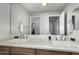 Bathroom with double sink vanity, a large mirror and modern fixtures at 4245 S 247Th Dr, Buckeye, AZ 85326