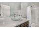 Bright bathroom features a vessel sink atop a granite countertop and a shower with white tile surround at 4245 S 247Th Dr, Buckeye, AZ 85326