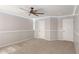 This bedroom features a modern ceiling fan and access to two entry doors at 4245 S 247Th Dr, Buckeye, AZ 85326