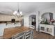 The dining area showcases wood floors, a decorative chandelier, and seamless access to the kitchen at 4245 S 247Th Dr, Buckeye, AZ 85326