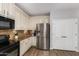 A kitchen featuring white cabinetry, stainless steel appliances, and complementary granite countertops at 4245 S 247Th Dr, Buckeye, AZ 85326