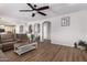 An open-concept living room with wood floors, complemented by neutral walls and modern lighting at 4245 S 247Th Dr, Buckeye, AZ 85326