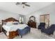 Stylish main bedroom features a king bed, dark wood furniture, and a ceiling fan for added comfort at 4245 S 247Th Dr, Buckeye, AZ 85326