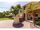 Backyard featuring an outdoor kitchen area and patio with desert landscaping at 4529 S Granite St, Gilbert, AZ 85297