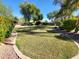 Beautifully maintained backyard with large grassy area and decorative rock border at 4529 S Granite St, Gilbert, AZ 85297