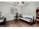 Bedroom with wood-look floors, a bright window, a desk chair, and ample shelving space at 4529 S Granite St, Gilbert, AZ 85297