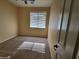 Neutral carpeted bedroom featuring a window and a ceiling fan at 4529 S Granite St, Gilbert, AZ 85297