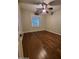 A bedroom with wood floors, a ceiling fan, and a window with shutter blinds at 4529 S Granite St, Gilbert, AZ 85297