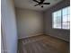 Neutral bedroom with carpet flooring, a ceiling fan, and a bright window at 4529 S Granite St, Gilbert, AZ 85297