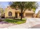 Inviting two-story home featuring a desert-landscaped front yard with shade from a large tree at 4529 S Granite St, Gilbert, AZ 85297