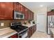 Well-equipped kitchen with stainless steel microwave and oven, dark wood cabinets, and ample counter space at 4529 S Granite St, Gilbert, AZ 85297