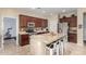 Kitchen featuring stainless steel appliances, a large central island with breakfast bar, and rich dark wood cabinets at 4529 S Granite St, Gilbert, AZ 85297