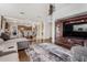 Open concept living room featuring a large tv console, view to dining and a stairway to upper floor at 4529 S Granite St, Gilbert, AZ 85297