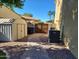 Practical side yard featuring brick pathway, storage sheds, and necessary utilities at 4529 S Granite St, Gilbert, AZ 85297