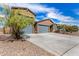 Charming single-story home featuring a gray garage door, desert landscaping, and a concrete driveway at 4642 W Suncup Dr, San Tan Valley, AZ 85144