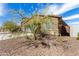 Charming single-story home featuring a gray garage door, desert landscaping, and a concrete driveway at 4642 W Suncup Dr, San Tan Valley, AZ 85144