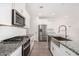 Well-equipped kitchen showcasing granite countertops, stainless steel appliances, and modern white cabinets at 4642 W Suncup Dr, San Tan Valley, AZ 85144