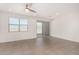 Minimalist living room with tile flooring, ceiling fan, window and sliding glass doors to the backyard at 4642 W Suncup Dr, San Tan Valley, AZ 85144