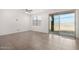 Minimalist living room with tile flooring, ceiling fan, window and sliding glass doors to the backyard at 4642 W Suncup Dr, San Tan Valley, AZ 85144