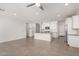 Open-concept living area flows into a modern kitchen with white cabinets and stainless steel appliances at 4642 W Suncup Dr, San Tan Valley, AZ 85144