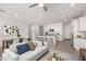 Bright and airy living room showcases an open floor plan with modern decor and a breakfast bar to the kitchen at 4642 W Suncup Dr, San Tan Valley, AZ 85144