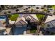 An aerial view of a house showcasing its landscaped front yard, brown roof, and modern architectural style at 4702 N 151St Dr, Goodyear, AZ 85395