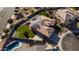 Overhead view of a home with a lush backyard, putting green, pool, gazebo, and energy-efficient solar panels at 4702 N 151St Dr, Goodyear, AZ 85395