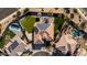 Aerial perspective of a modern home with a tiled roof and a landscaped backyard with a charming gazebo at 4702 N 151St Dr, Goodyear, AZ 85395