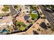 Aerial view of a home featuring solar panels, a green backyard with a pool, and an outdoor living space at 4702 N 151St Dr, Goodyear, AZ 85395