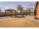 Spacious backyard with a gazebo, fire pit, and xeriscaping at 4702 N 151St Dr, Goodyear, AZ 85395