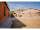 Backyard featuring tall fence, gate and a concrete slab at 4702 N 151St Dr, Goodyear, AZ 85395