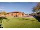 Large backyard featuring artificial grass, brick pavers and an outdoor gazebo at 4702 N 151St Dr, Goodyear, AZ 85395