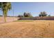 Desert backyard with brick fence and putting green at 4702 N 151St Dr, Goodyear, AZ 85395