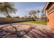 Beautifully landscaped backyard featuring sand pit and brick patio at 4702 N 151St Dr, Goodyear, AZ 85395