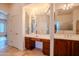 Bathroom featuring a vanity with mirrored accent lighting, and wood cabinets at 4702 N 151St Dr, Goodyear, AZ 85395