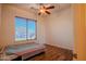 Bedroom featuring hard wood floors, ceiling fan, and a window bringing in natural light at 4702 N 151St Dr, Goodyear, AZ 85395